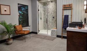 Remodeled shower area with walk-in functionality, tile surrounds, and built-in seating